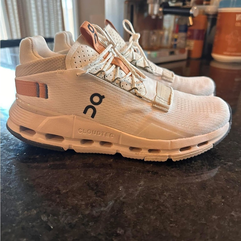 On Running White and Orange Athletic Shoes